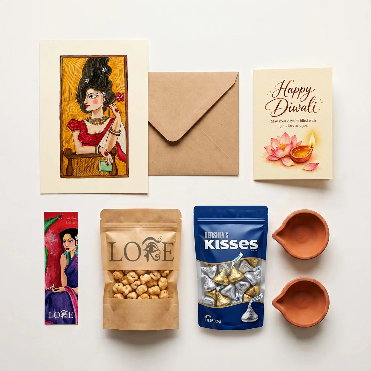 Lore Roshni Diwali hamper contents – art print with envelope, Diwali card, bookmark, roasted chana, Hershey's Kisses and two clay diyas