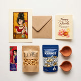 Lore Roshni Diwali hamper contents – art print with envelope, Diwali card, bookmark, roasted chana, Hershey's Kisses and two clay diyas