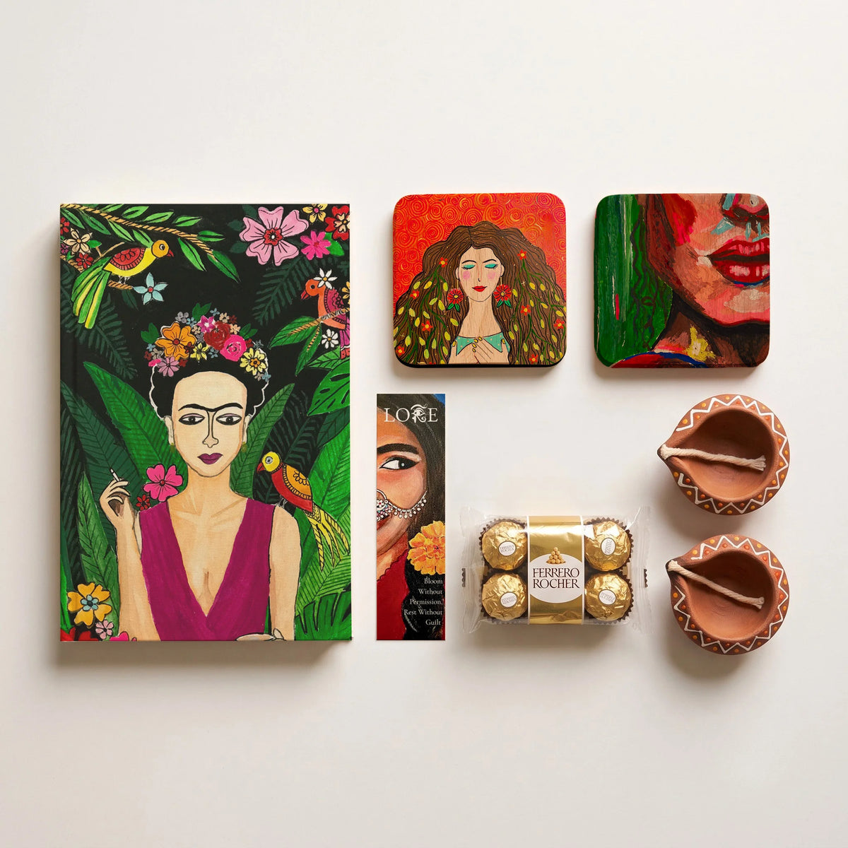 Lore Kahaani Diwali hamper contents – art journal, two art coasters, bookmark, Ferrero Rocher and two hand-painted diyas
